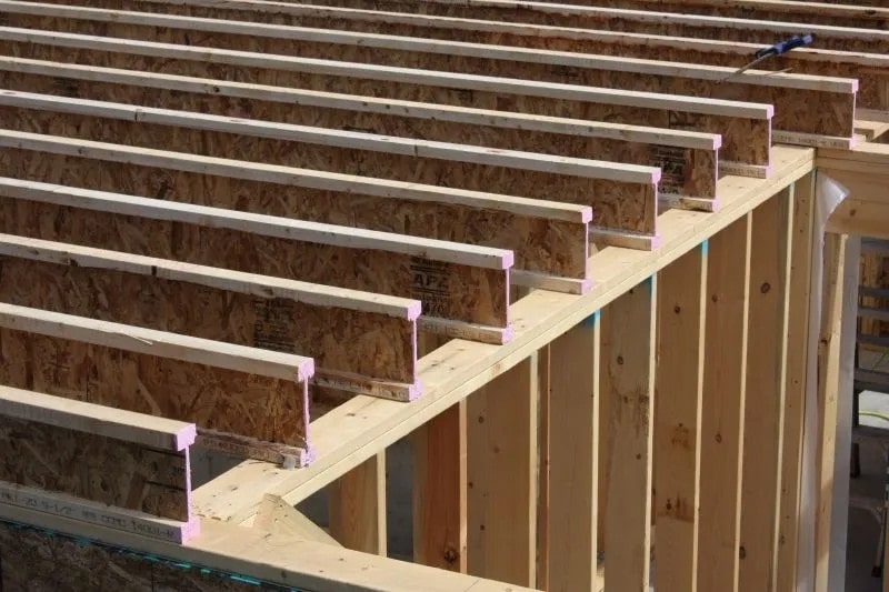 Wood I-joists installed as a floor system over framed walls
